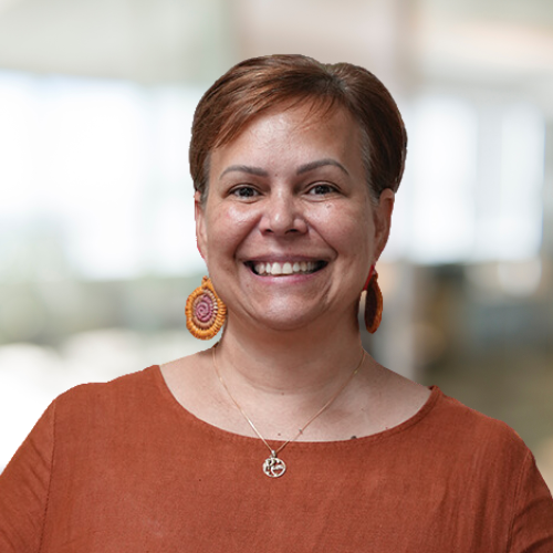 head shot of Cindy Torrens, CEO of NAAFLS. Smiling wearing deep ochre dress.